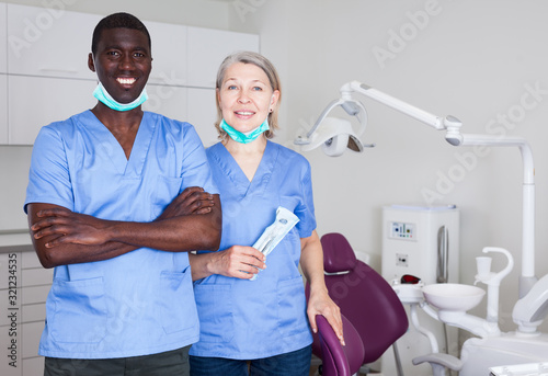 Dentist with assistant in the workplace in clinic photo