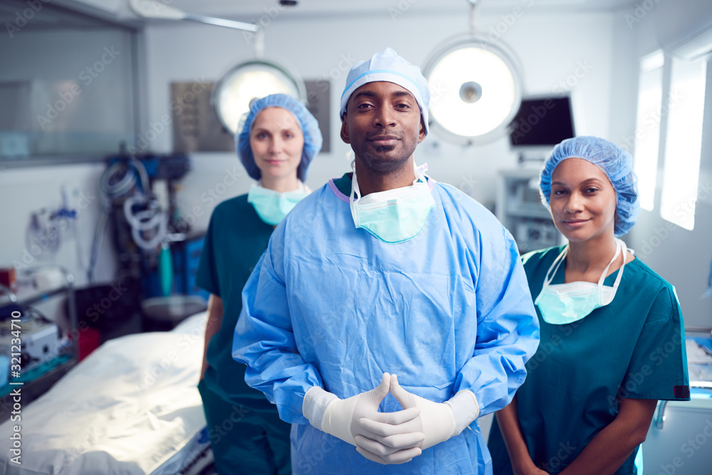 Obraz premium Portrait Of Multi-Cultural Surgical Team Standing In Hospital Operating Theater