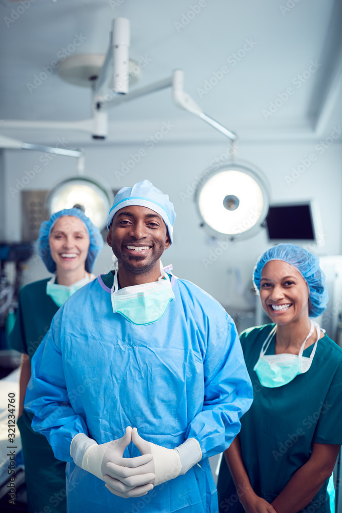 Portrait Of Multi-Cultural Surgical Team Standing In Hospital Operating Theater Portrait Of Multi-Cultural Surgical Team Standing In Hospital Operating Theater