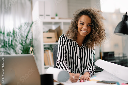 African architect working on new project. Businesswoman in office.  photo