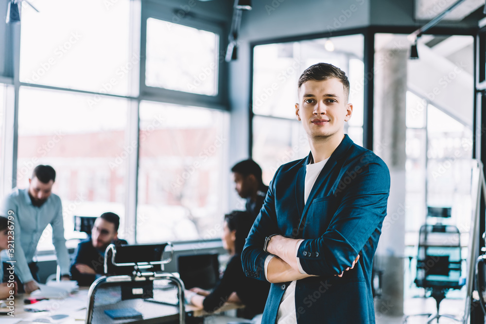 Young employee standing in office Young employee standing in office