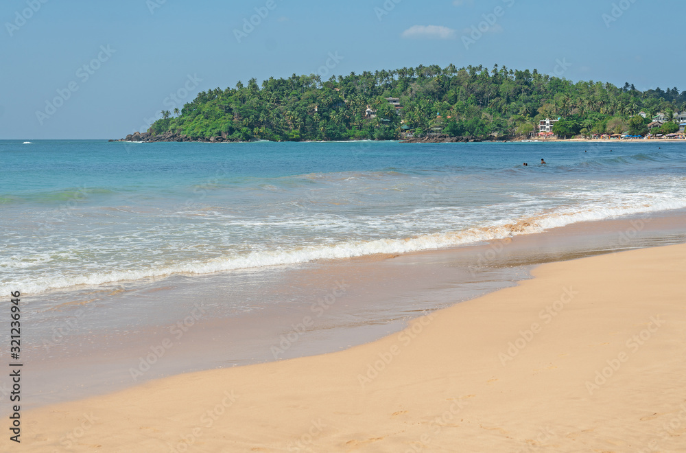 Ocean island sand beach landscape with blue water, Mirissa, Sri Lanka