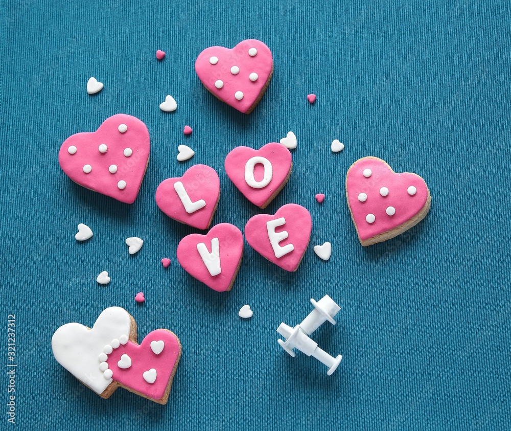 Composition with decorated heart shaped cookies and space for text on blue background, top view. Valentine's day