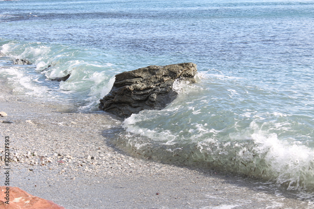 One solid stone against waves One solid stone against waves
