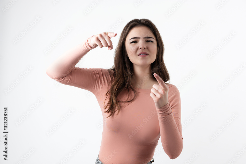young beautiful brunette woman standing on isolated white background pointing with her fingers on both hands