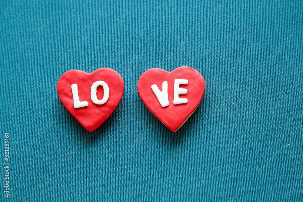 Composition with decorated heart shaped cookies and space for text on blue background, top view. Valentine's day Composition with decorated heart shaped cookies and space for text on blue background, top view. Valentine's day