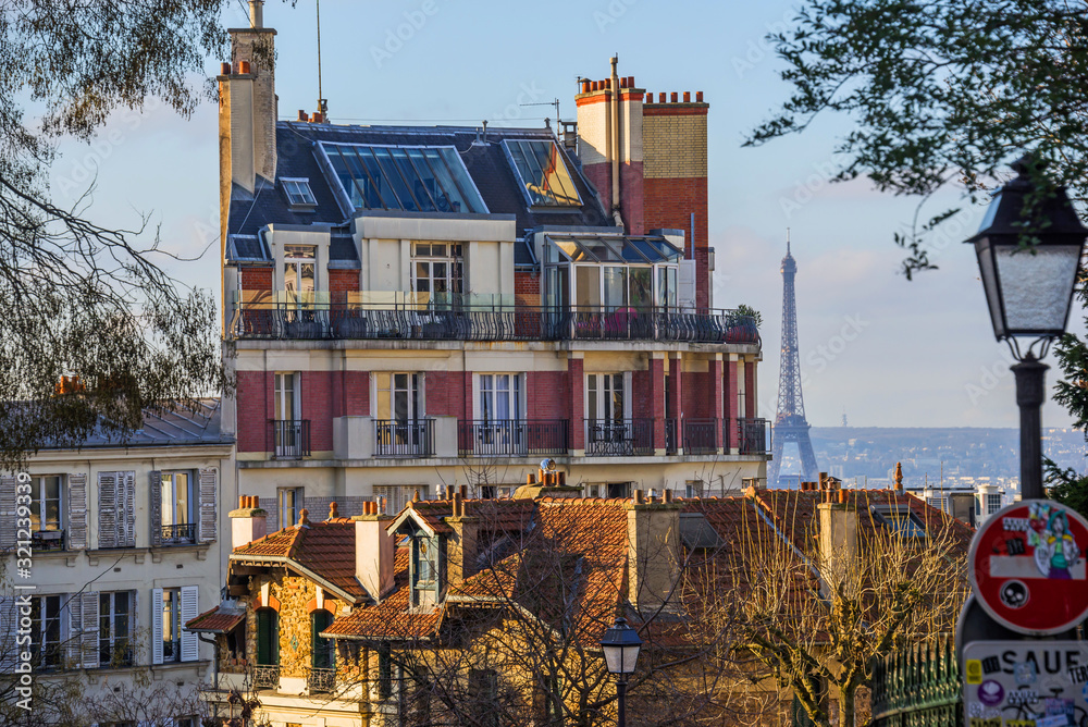 FEBRUARY 1, 2019 - PARIS, FRANCE: Panoramic view over Paris from Montmartre, apartment buildings in forefront, Eiffel tower in distance