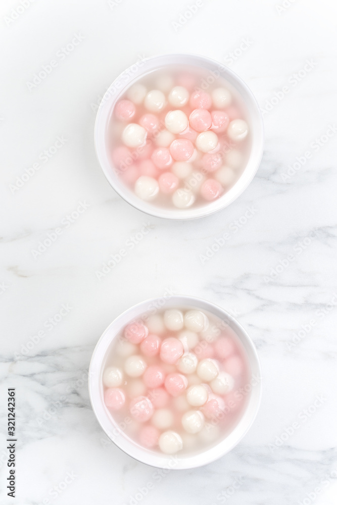 Tang yuan, tangyuan, delicious red and white rice dumpling balls in a small bowl, top view, flat lay. Asian festive food for Winter Solstice Festival. Tang yuan, tangyuan, delicious red and white rice dumpling balls in a small bowl, top view, flat lay. Asian festive food for Winter Solstice Festival.