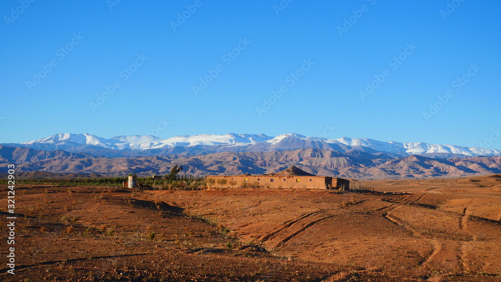 Naklejka premium Bright landscape of Morocco, breathtaking curves of mountains, stunning combination of hills & farm land,inadvertent distribution of houses & huts, raw impression of pure nature.