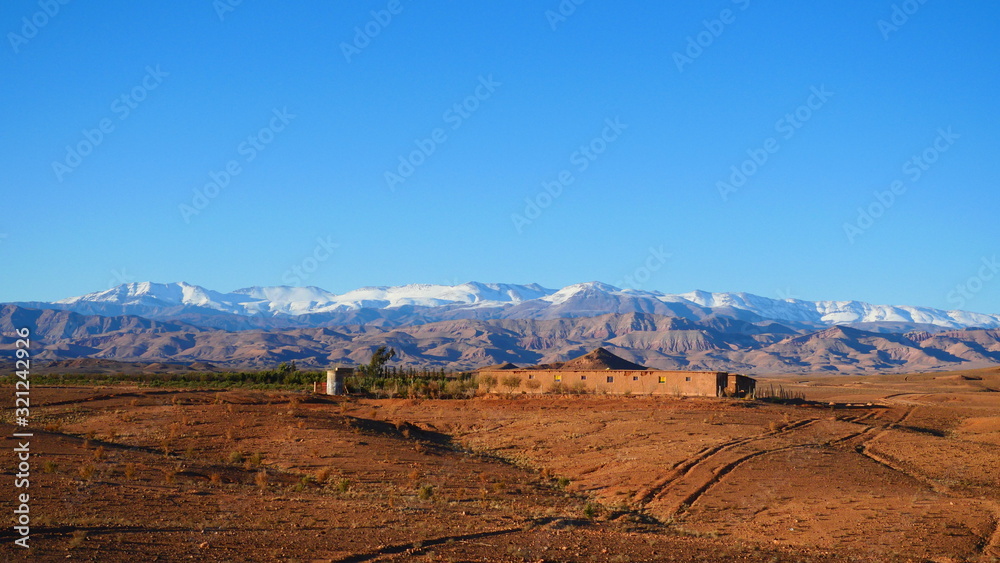 Bright landscape of Morocco, breathtaking curves of mountains, stunning combination of hills & farm land,inadvertent distribution of houses & huts, raw impression of pure nature.