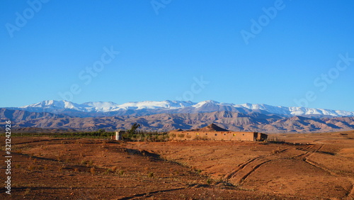 Bright landscape of Morocco, breathtaking curves of mountains, stunning combination of hills & farm land,inadvertent distribution of houses & huts, raw impression of pure nature.
