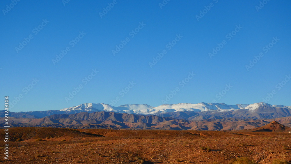 Bright landscape of Morocco, breathtaking curves of mountains, stunning combination of hills & farm land,inadvertent distribution of houses & huts, raw impression of pure nature.