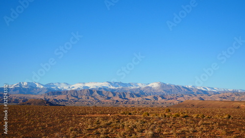 Bright landscape of Morocco  breathtaking curves of mountains  stunning combination of hills   farm land inadvertent distribution of houses   huts  raw impression of pure nature.