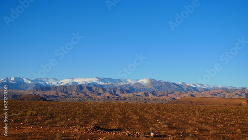 Bright landscape of Morocco, breathtaking curves of mountains, stunning combination of hills & farm land,inadvertent distribution of houses & huts, raw impression of pure nature.