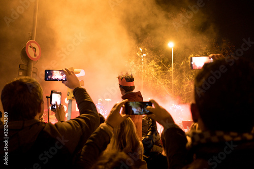 Barcelona, Spain - 5 january 2020: a child watches the traditional cabalgata de reyes at night, a catalan tradition celebrating the arrival of the three kings photo