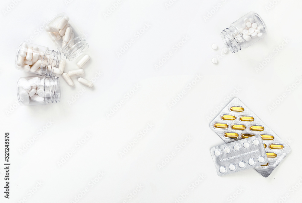 Four packages with various white pills and golden tablets in a blister pack on a white background. Health concept. Top view with copy space.