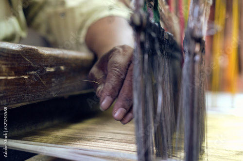 Man weaving loom