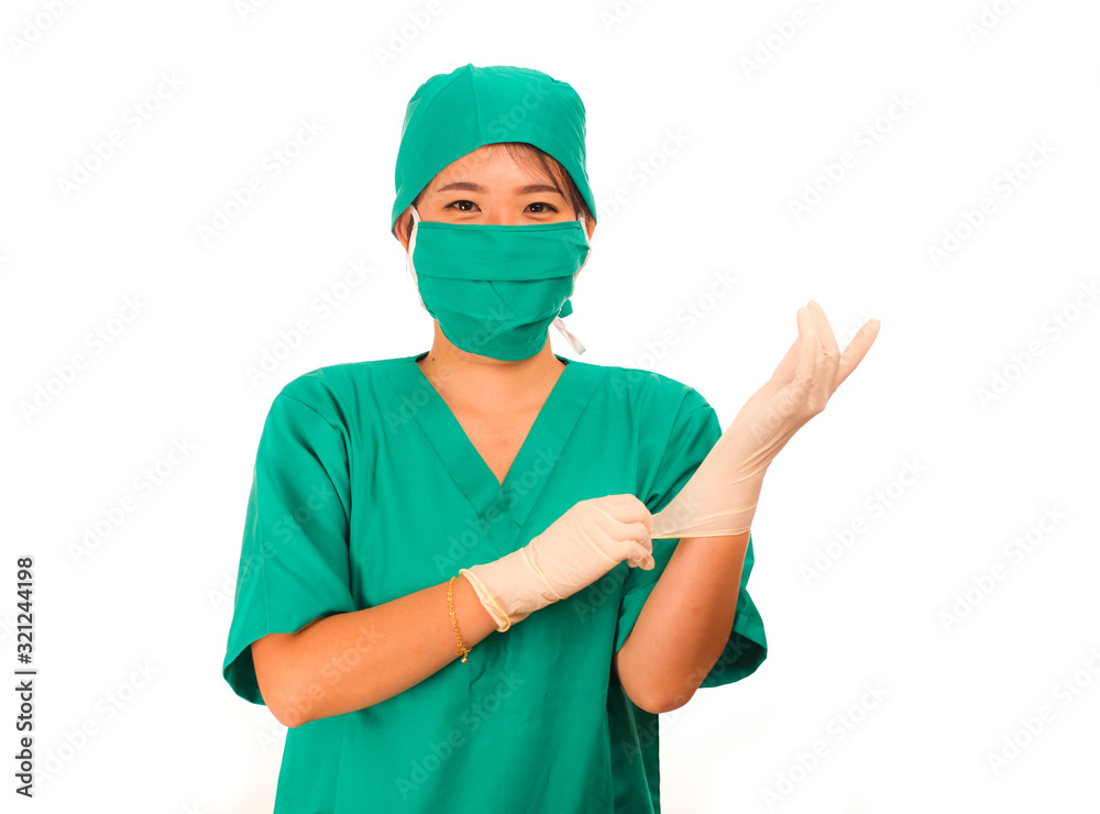 young beautiful and happy medicine doctor or chief hospital nurse in green scrubs and surgey hat and mask wearing protective latex gloves young beautiful and happy medicine doctor or chief hospital nurse in green scrubs and surgey hat and mask wearing protective latex gloves
