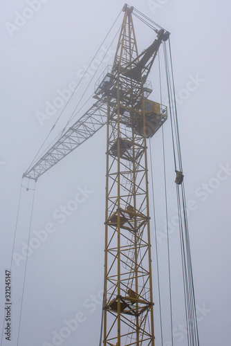 Construction crane in the fog