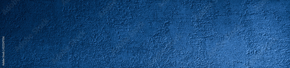 Blue grunge background. Texture of the rough surface of a concrete wall. Blue grunge banner with copy space for your design.