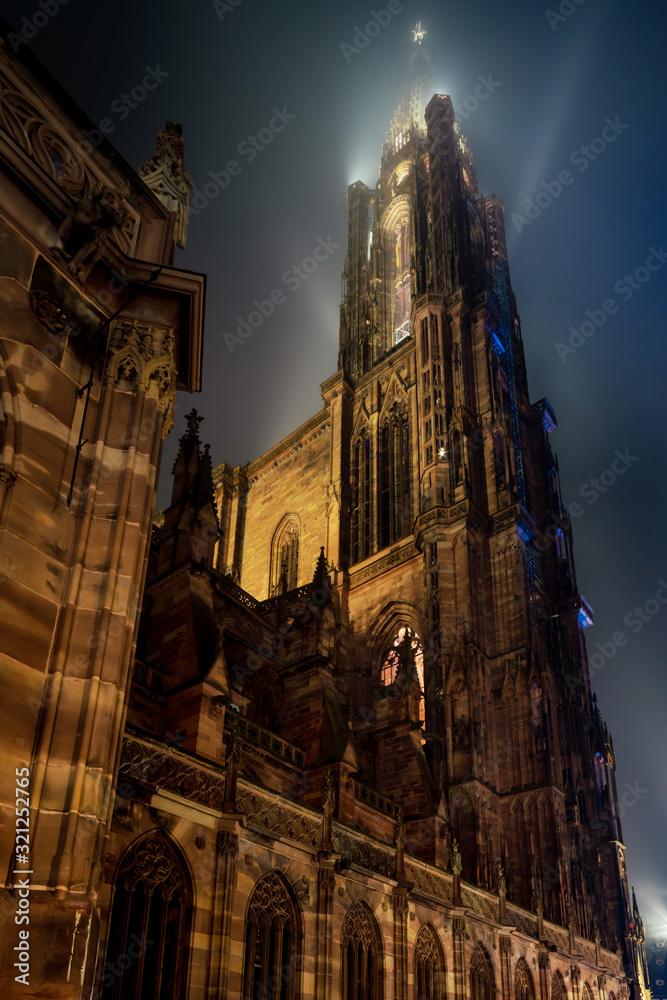 Fototapeta premium Stunning bottom view of Strasbourg Cathedral illuminated at night, Europe's tallest building.
