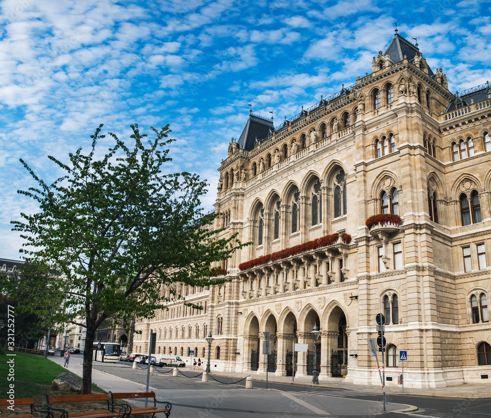 Town Hall under blue cloudy sky in Vienna, Austria. Beautiful facade of Rathaus, gothic building
