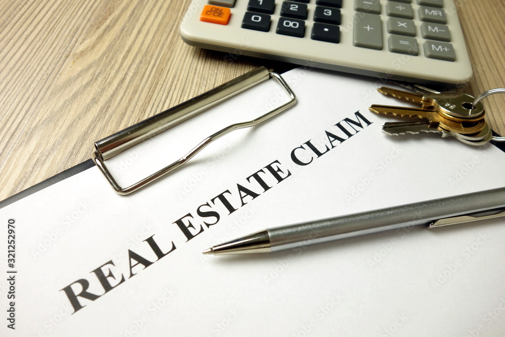 Fototapeta premium Real estate claim form with pen keys and calculator