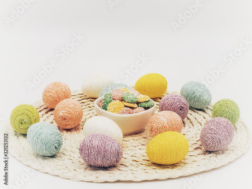 Round placemat topped with Easter eggs covered in sparkly string