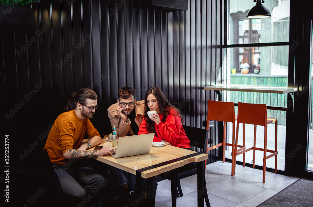 Young People at Fast Food Restaurant looking at Laptop Young People at Fast Food Restaurant looking at Laptop