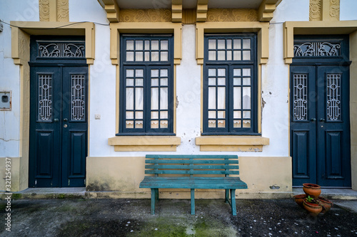 Cute beach houses with blue doors and bench in Costa Nova Portugal
