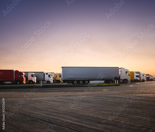 trucks parked in the parking lot at sunrise