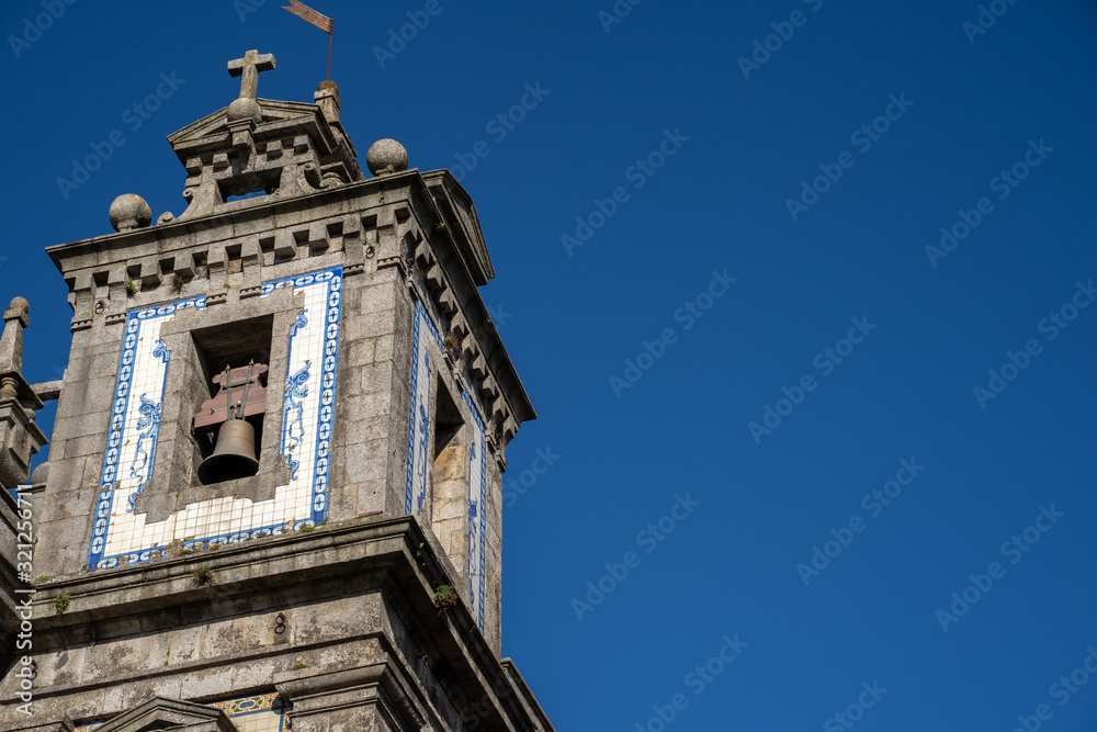 Exterior of the Church of Saint Ildefonso in Porto, Portugal on a sunny day - on the bell tower