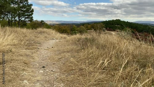 POV walk on trail along the hill in autumn. Outskirts of the city Simferopol