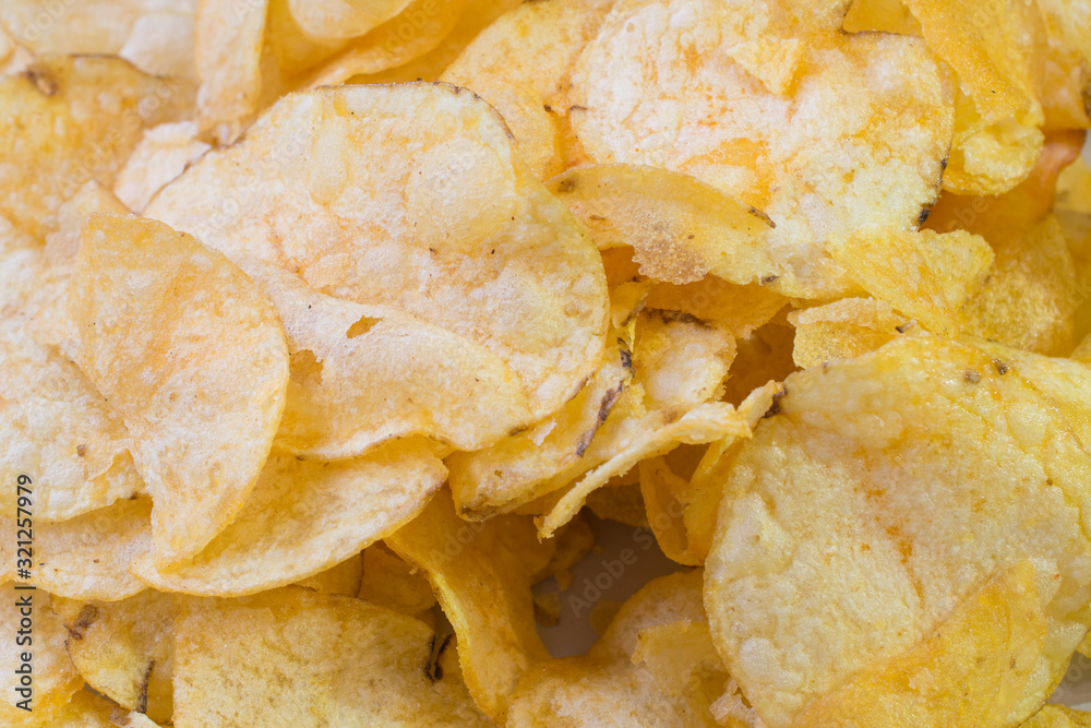 Potato chips on a plate background