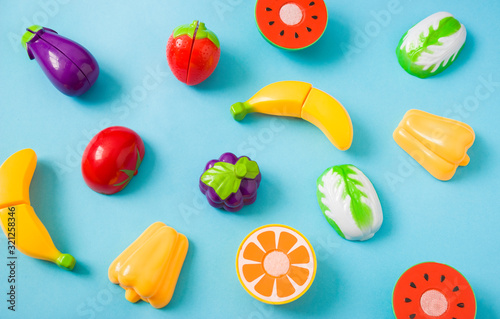 Plastic food children's toys on a blue background. The concept of healthy eating, nutrition for children.