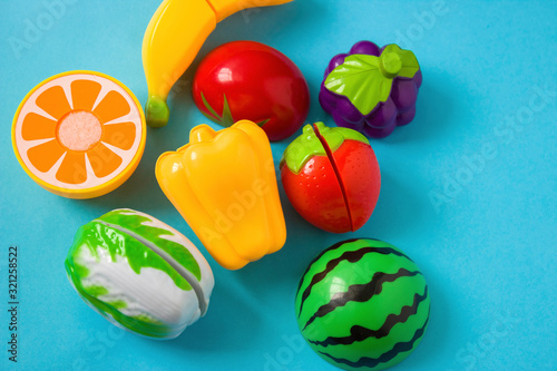 Plastic food children's toys on a blue background. The concept of healthy eating, nutrition for children.