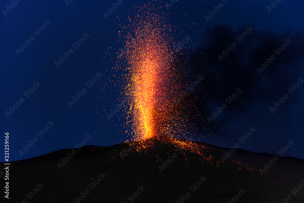 explosive eruption at dusk in one of the three craters of the active stromboli volcano, eolian islands, italy.