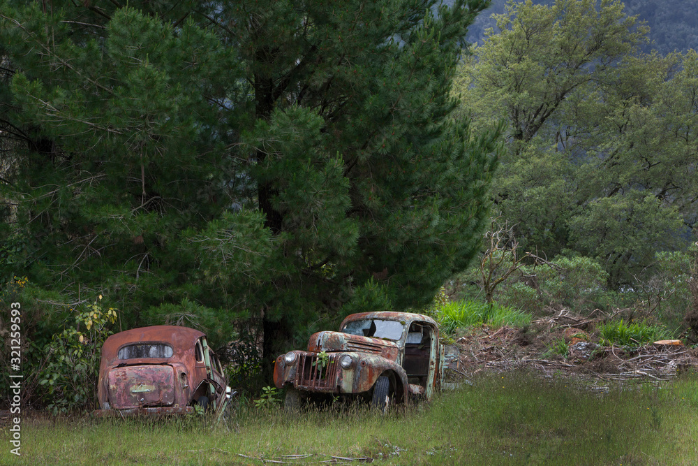 Junkyard. Oldtimer cars. Buller river Highway 6 New Zealand. Carwreck. Rusty Junkyard. Oldtimer cars. Buller river Highway 6 New Zealand. Carwreck. Rusty