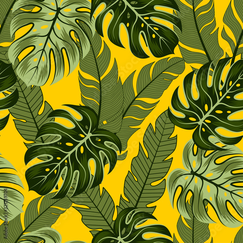 Exotic seamless tropical pattern with bright plants and leaves on a yellow background. Seamless pattern with colorful leaves and plants. Beautiful exotic plants.
