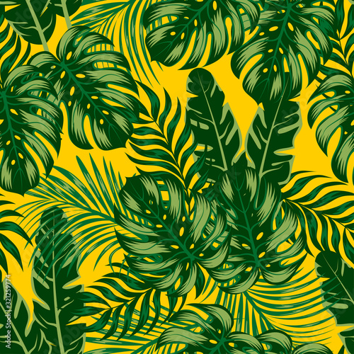 Exotic seamless tropical pattern with bright plants and leaves on a yellow background. Modern abstract design for fabric, paper, interior decor.