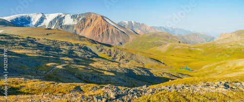 Panoramic view of a mountain valley. Tundra, treeless mountain slopes. Traveling in the mountains, trekking.