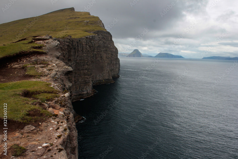 High cliff into the ocean. Location - Faroe Islands