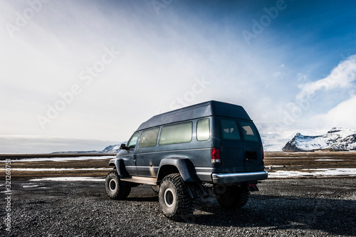 Holiday in Iceland:Exploring the island in 4x4 blue monster van near Jokulsarlon in Breidamerkursandur,  Austurland region.Discovering the world. photo