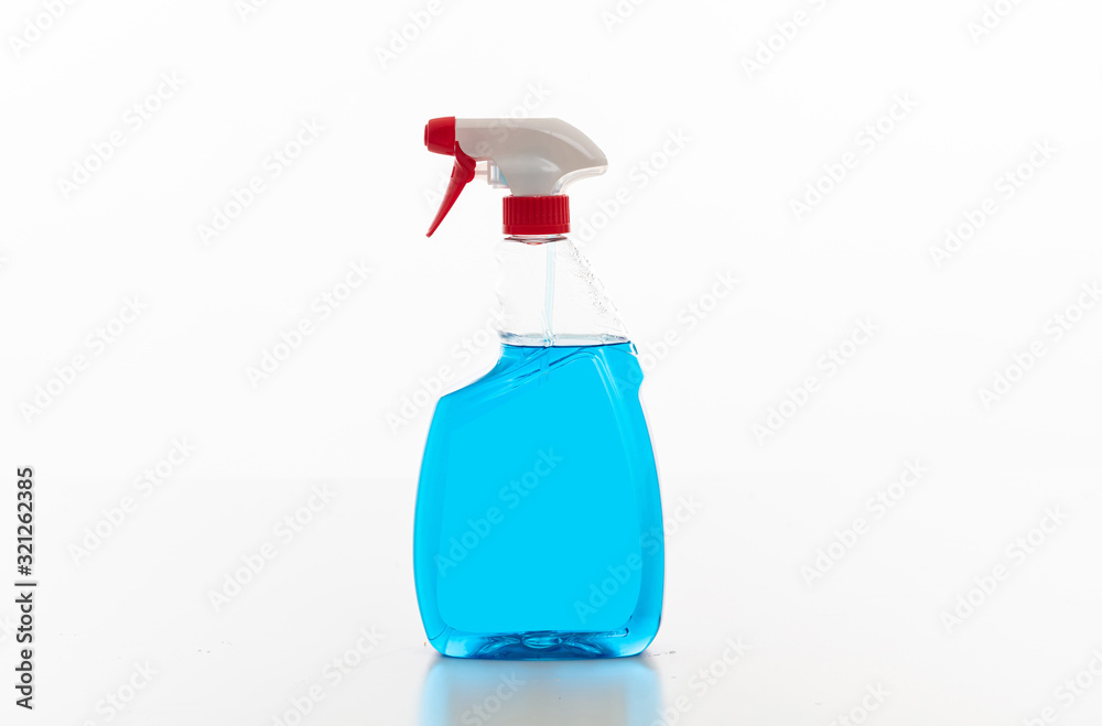 Cleaning spray bottle clear with blue color fluid isolated against white background. Cleaning spray bottle clear with blue color fluid isolated against white background.