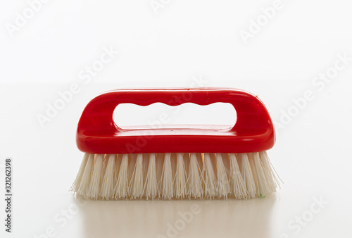 Valokuva Cleaning brush red color isolated against white background.