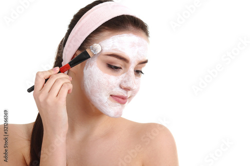 young beautiful woman with facial mask, spa treatment photo