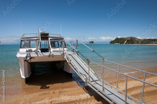 Kaiteriteri watertaxi at beach New Zealand Abel tasman Notional Park photo