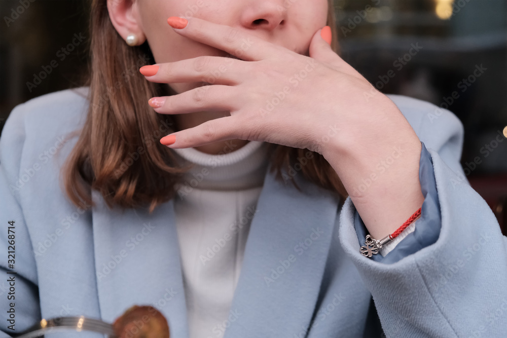 Close up of hands woman using toothpick in mouth after eating