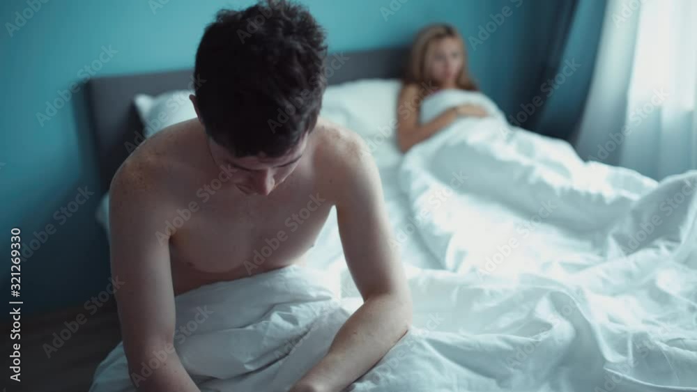 Heterosexual couple having problem in bed. Man fabbing and doesn't pay attantion to her girlfriend. Marriage, phone addiction, family, love, sex concept.