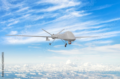 Military uav drone flight flies above the clouds.